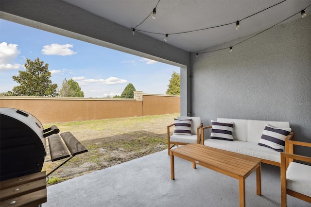 view of patio with grilling area, fence, and an outdoor hangout area