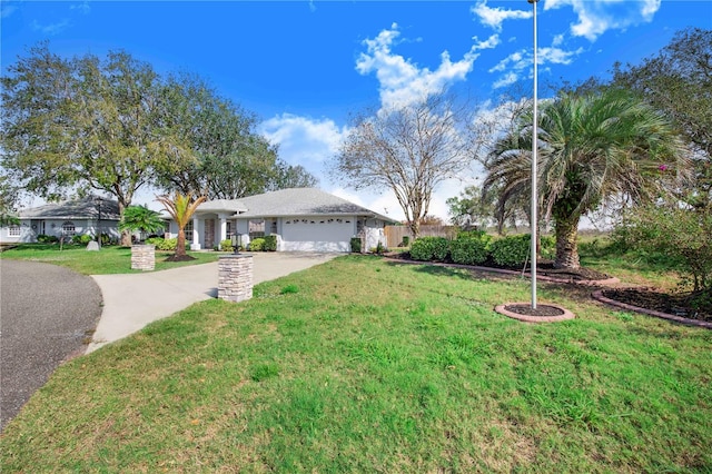 ranch-style house featuring driveway, an attached garage, and a front lawn