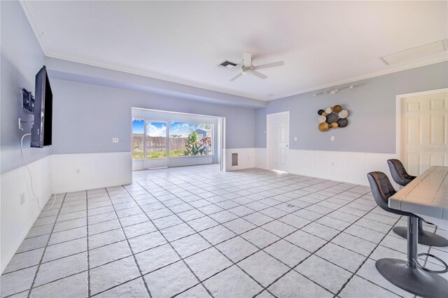 home office with visible vents, wainscoting, a ceiling fan, and crown molding