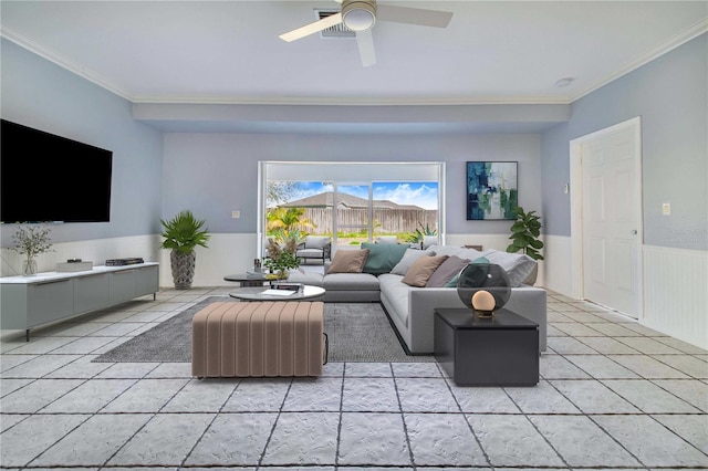 living room featuring ceiling fan, wainscoting, light tile patterned flooring, and crown molding