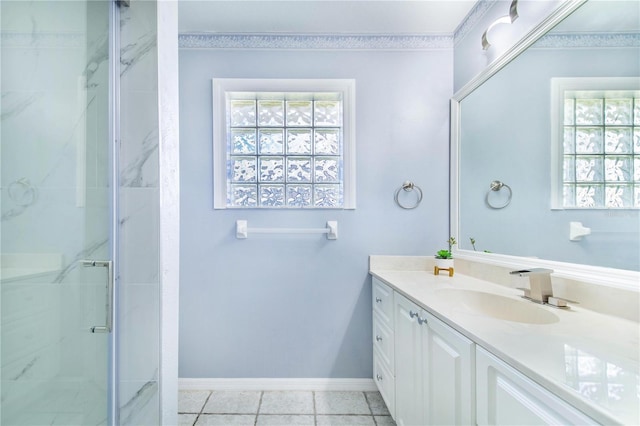 full bath featuring plenty of natural light, a marble finish shower, vanity, and baseboards