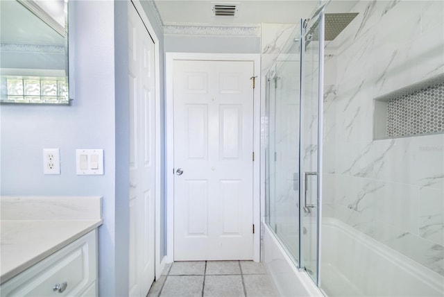 bathroom with shower / bath combination with glass door, tile patterned floors, visible vents, and vanity