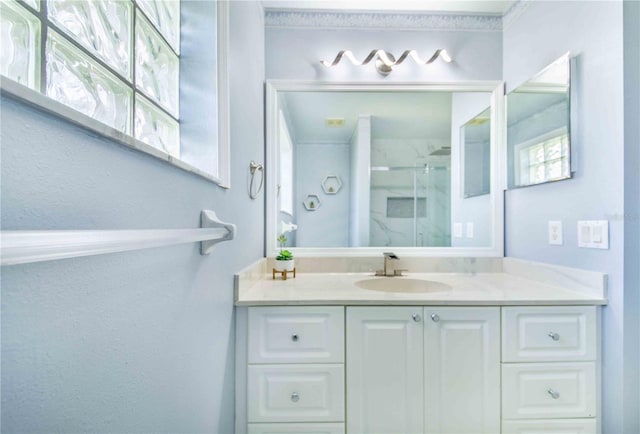 bathroom with a shower stall and vanity