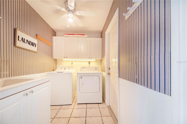 laundry area featuring light tile patterned floors, a ceiling fan, cabinet space, washer and clothes dryer, and wallpapered walls