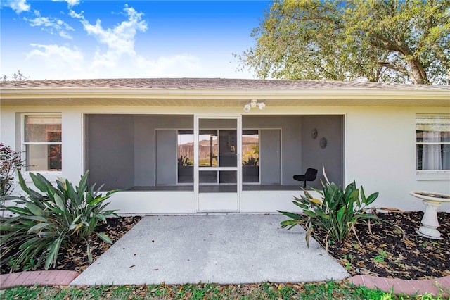 property entrance featuring stucco siding