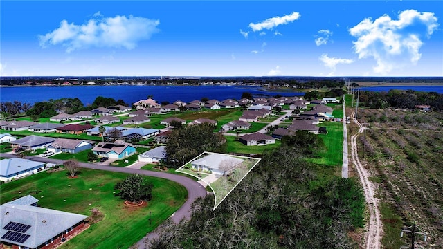 birds eye view of property with a water view and a residential view