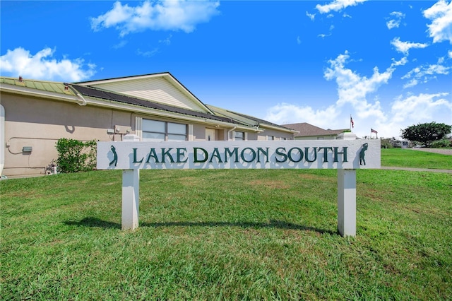 community sign featuring a lawn