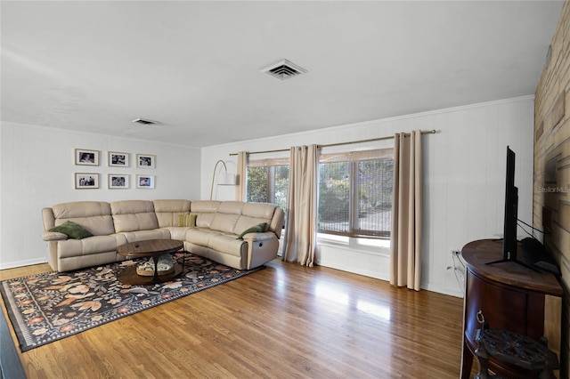 living area featuring wood finished floors and visible vents