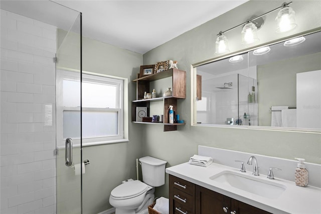 full bathroom featuring vanity, toilet, and a shower stall