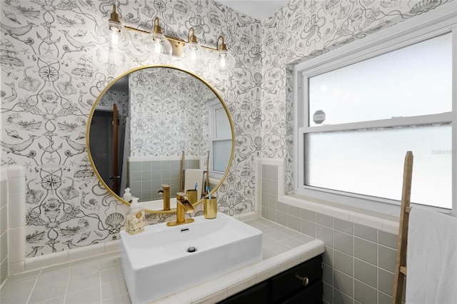 bathroom featuring tile patterned flooring, wallpapered walls, and vanity