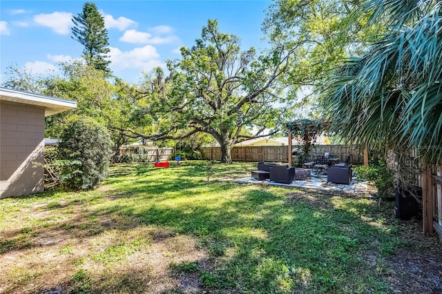 view of yard with a patio, a fenced backyard, and an outdoor hangout area