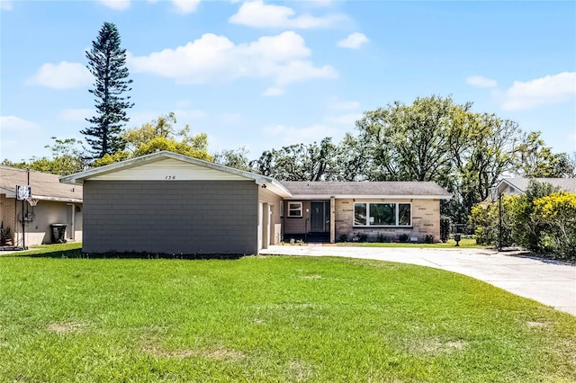 single story home with concrete driveway, a garage, and a front yard