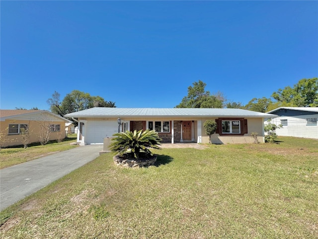 single story home with a garage, a front lawn, metal roof, and driveway