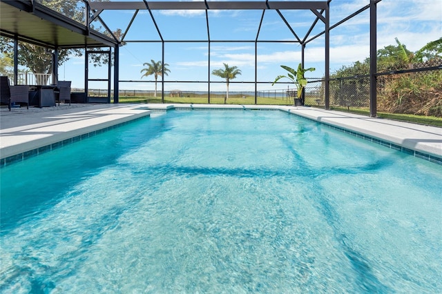 pool with glass enclosure and a patio