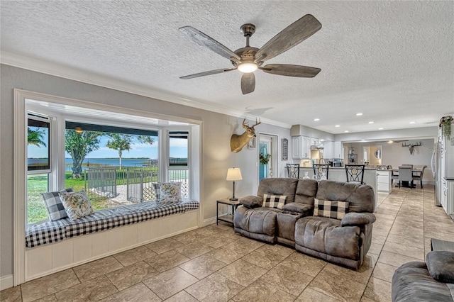 living room with baseboards, recessed lighting, ceiling fan, ornamental molding, and a textured ceiling