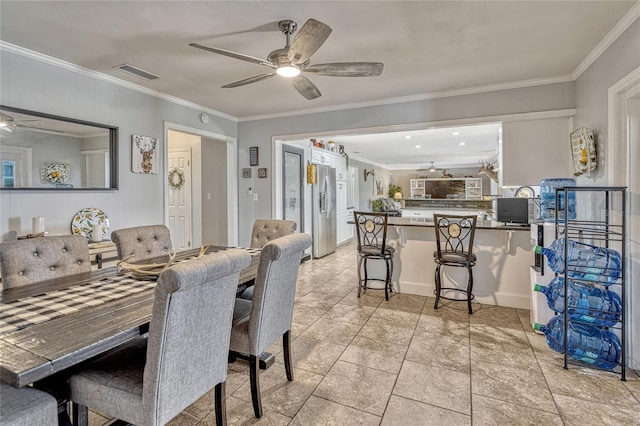 dining space with visible vents, ceiling fan, and ornamental molding