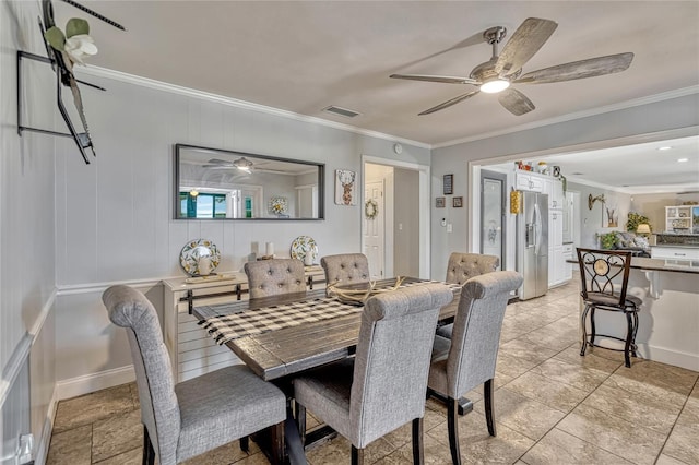 dining area with visible vents, baseboards, crown molding, and a ceiling fan