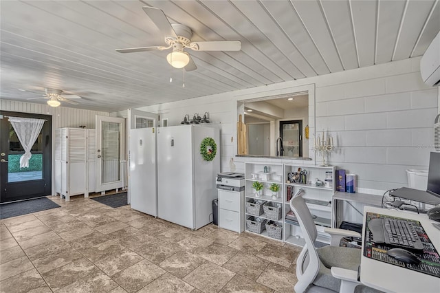 interior space featuring wood ceiling, freestanding refrigerator, and a ceiling fan