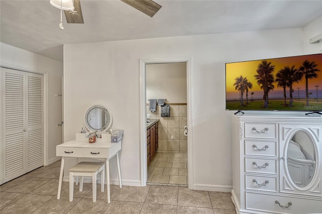 bathroom featuring tile patterned floors, vanity, and a closet