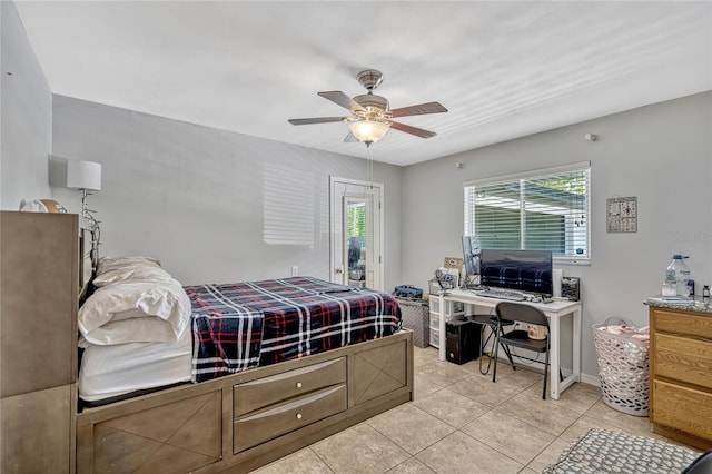 bedroom featuring access to outside, light tile patterned floors, a ceiling fan, and baseboards