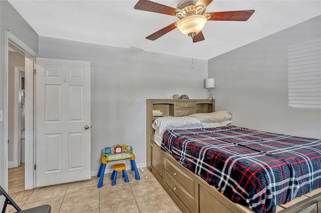 bedroom featuring light tile patterned floors, baseboards, visible vents, and ceiling fan