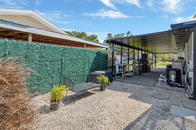 view of yard featuring a carport and a patio area