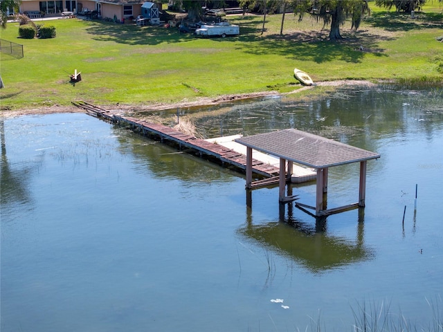 dock area with a yard and a water view