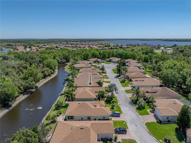 birds eye view of property with a water view and a residential view