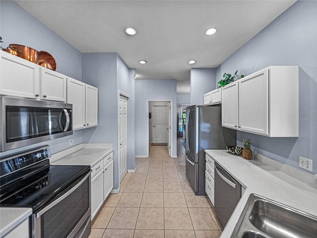 kitchen featuring white cabinetry, light countertops, recessed lighting, light tile patterned flooring, and appliances with stainless steel finishes