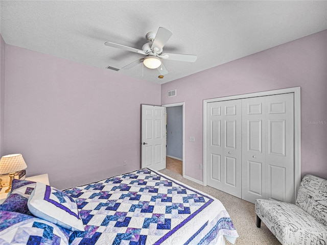 bedroom featuring a closet, carpet flooring, ceiling fan, and visible vents