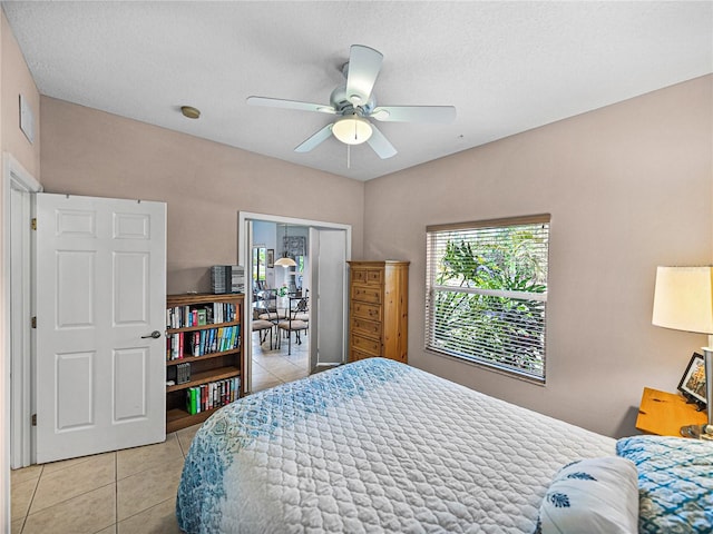 bedroom featuring a ceiling fan and light tile patterned floors