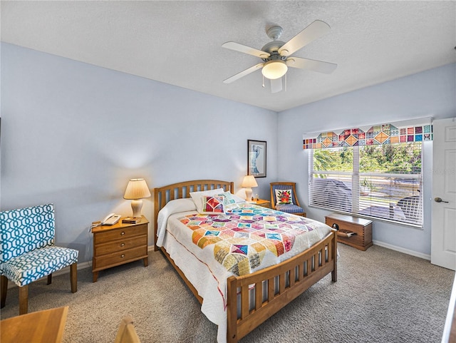 bedroom with baseboards, a textured ceiling, a ceiling fan, and carpet