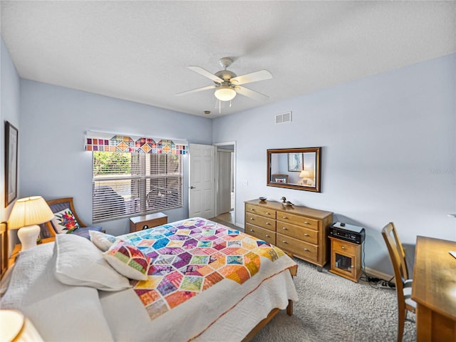 bedroom featuring a ceiling fan, light colored carpet, and visible vents