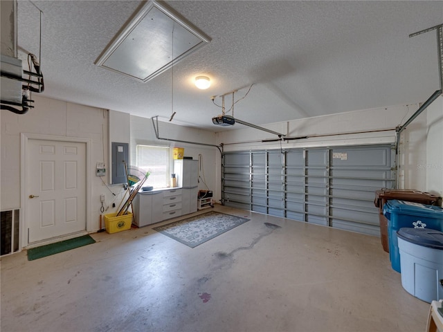 garage with a garage door opener and electric panel