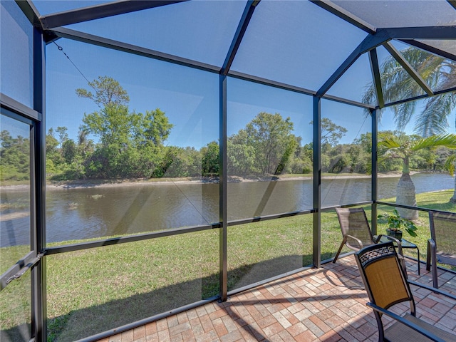 unfurnished sunroom featuring a water view