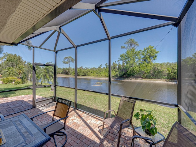 unfurnished sunroom featuring a water view