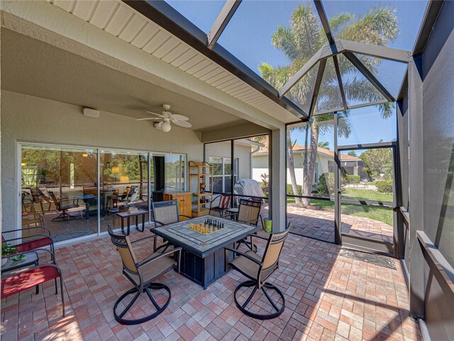 sunroom / solarium featuring an outdoor fire pit, beam ceiling, and ceiling fan