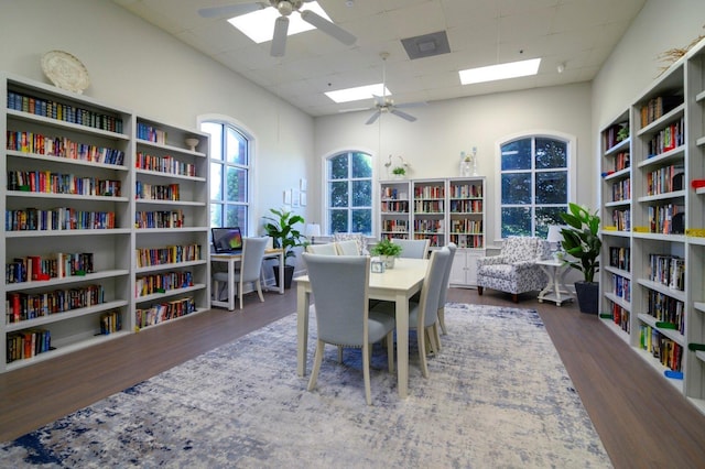 dining area featuring a drop ceiling, wood finished floors, and ceiling fan