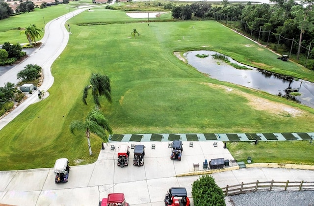 aerial view featuring golf course view and a water view