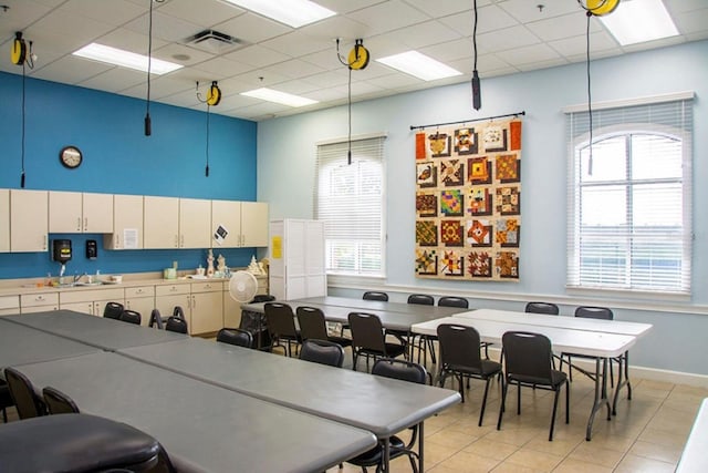 kitchen featuring light tile patterned flooring, visible vents, a sink, and a paneled ceiling