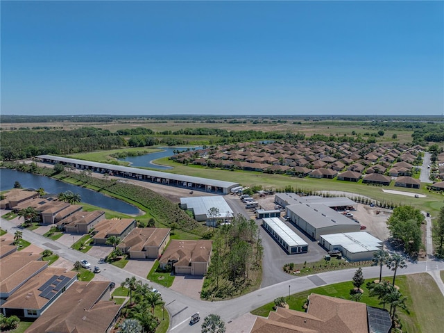 drone / aerial view featuring a residential view and a water view