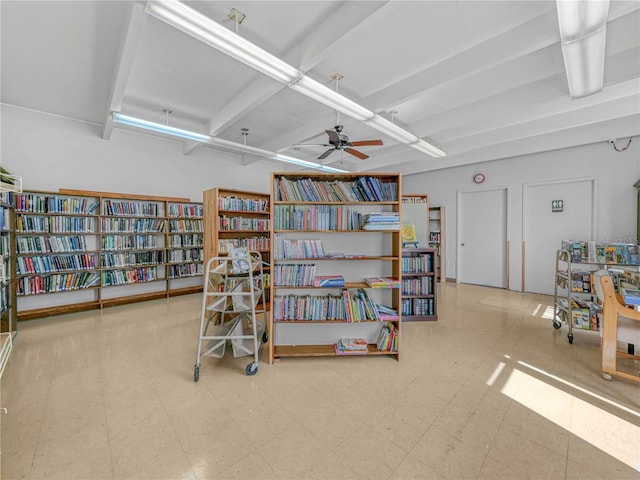 miscellaneous room with tile patterned floors, ceiling fan, and bookshelves