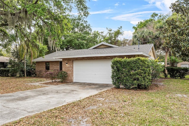 view of front of home with a garage, brick siding, driveway, and roof with shingles