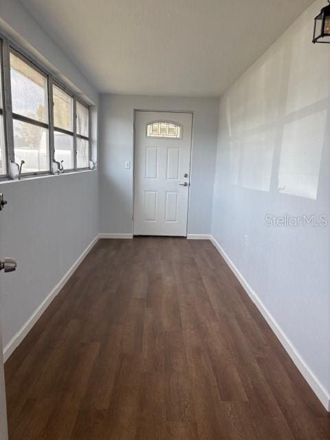 entryway featuring dark wood-type flooring and baseboards