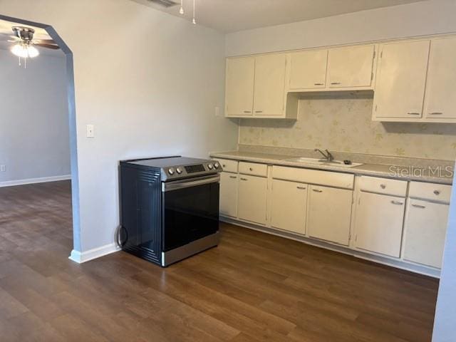 kitchen with stainless steel electric range oven, light countertops, ceiling fan, and a sink