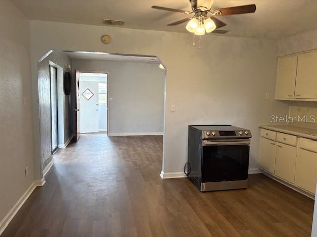 kitchen with electric range, baseboards, visible vents, and dark wood-style flooring