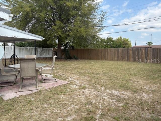 view of yard with a patio area and a fenced backyard