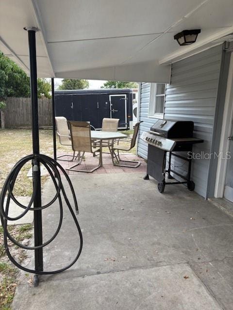 view of patio / terrace with area for grilling, outdoor dining area, and fence