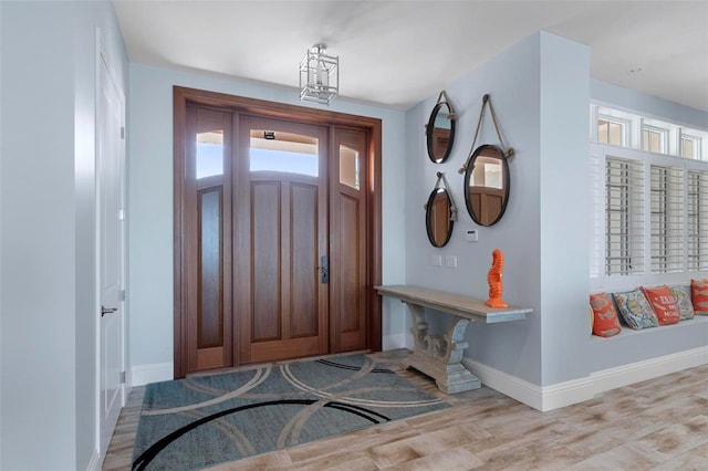 foyer entrance featuring wood finished floors and baseboards