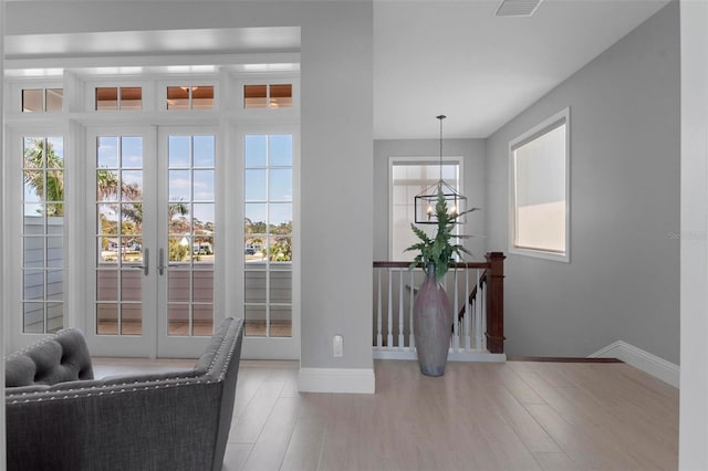 doorway to outside with baseboards and wood finished floors